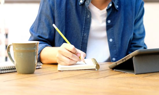 Online studying class, Student man hand writing on notebook while using digital tablet for e learning, Adult male university, college student study online course at home, education, Work from home